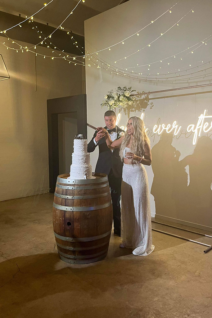 The newlyweds cutting their wedding cake.
