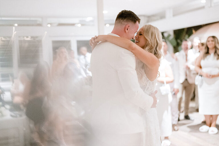 The bride and groom dancing together.