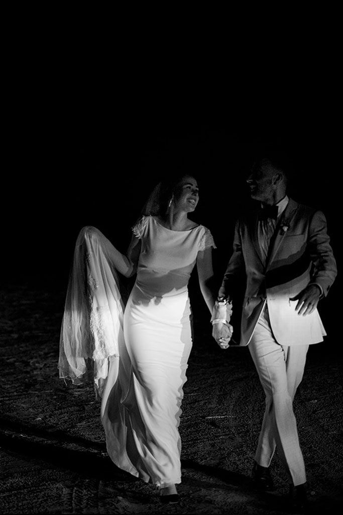 Newlyweds walking, holding hands.