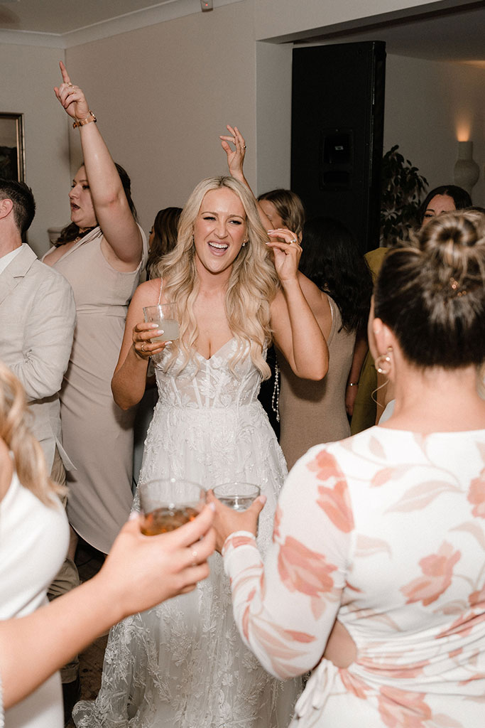 The bride dancing with the wedding guests.