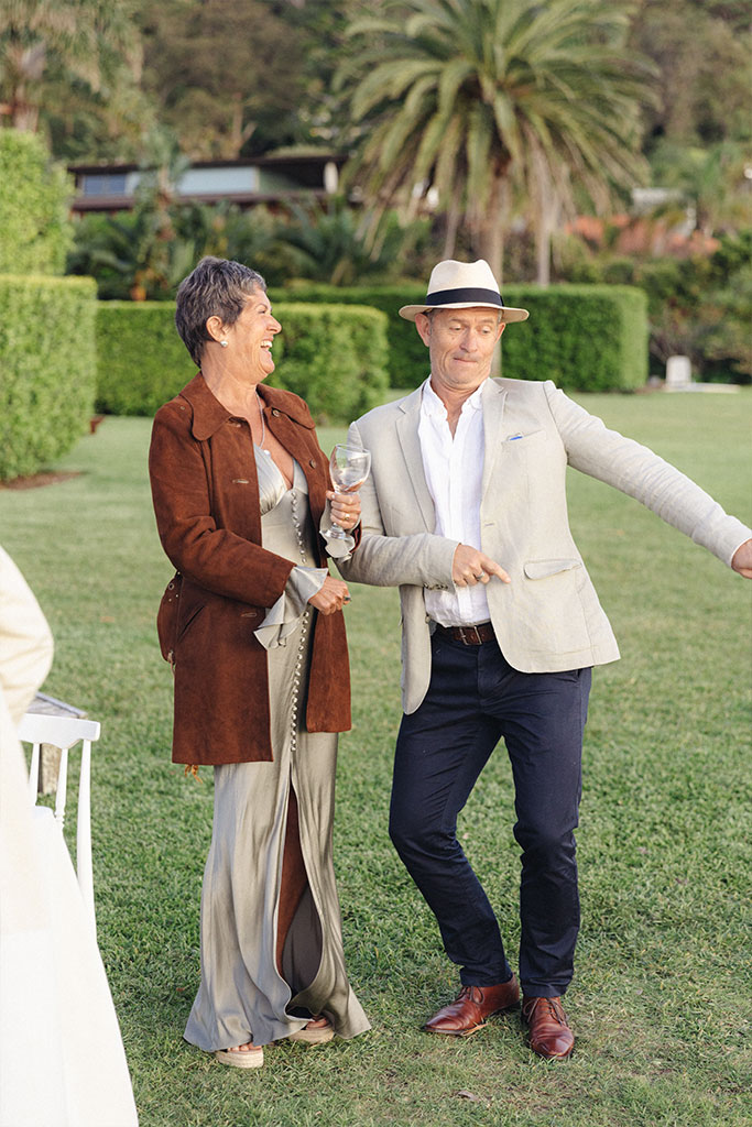 A man dancing and a woman laughing at him.