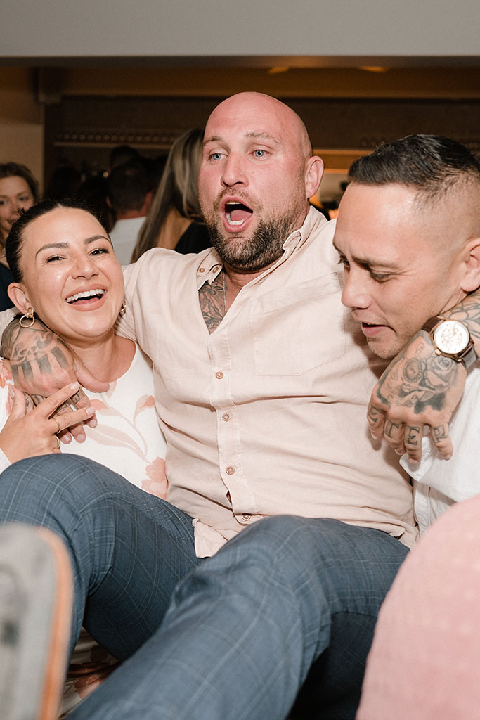 A man being carried by two other people.