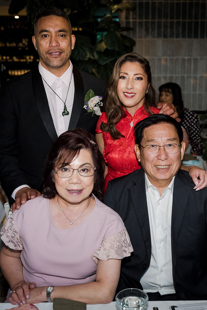a photo of the bride and groom with their family at their wedding