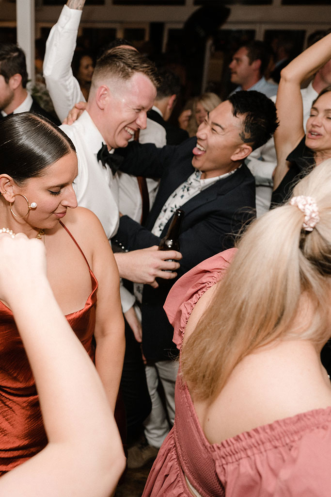 The groom dancing with the wedding guests.
