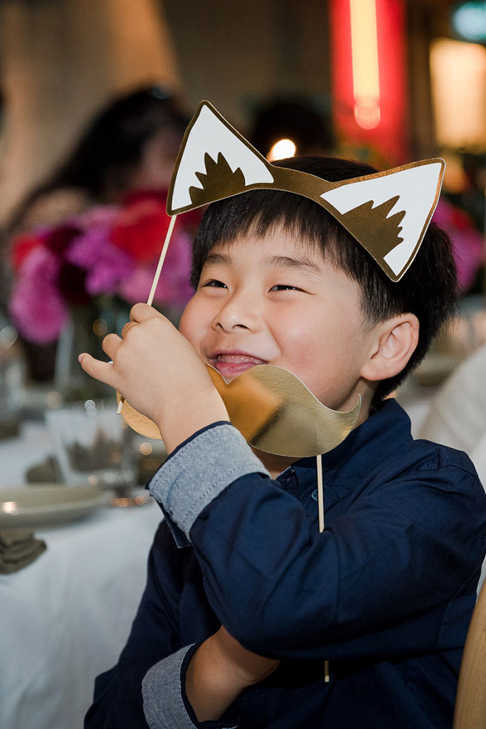 a photo of a kid with props at the wedding