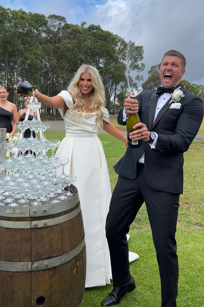 The couple popping champagne.