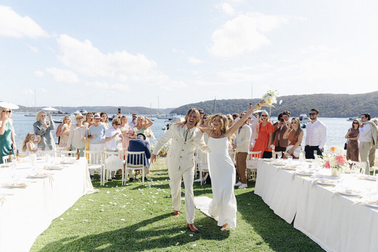 Newlyweds happily walk down the aisle at their wedding ceremony.