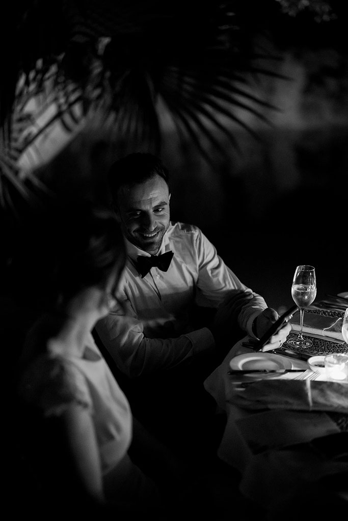 A groom smiling looking at his bride.