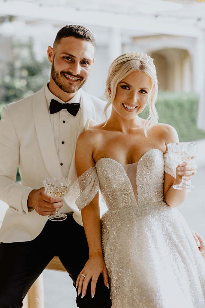 A bride and groom smiling on their wedding day.
