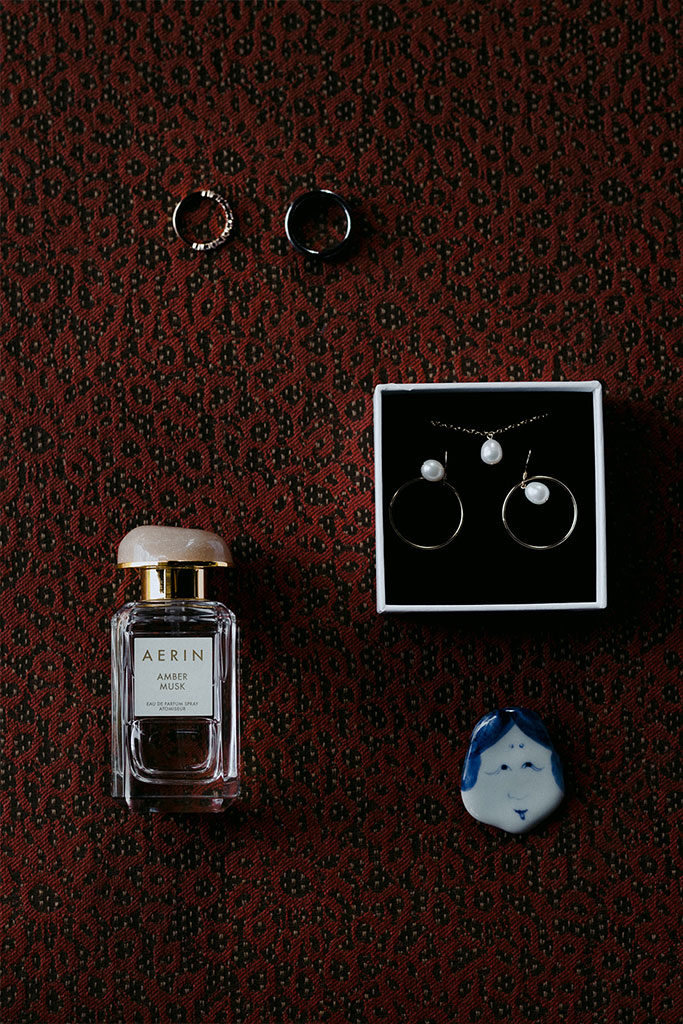 Perfume bottle, ring, and earrings.