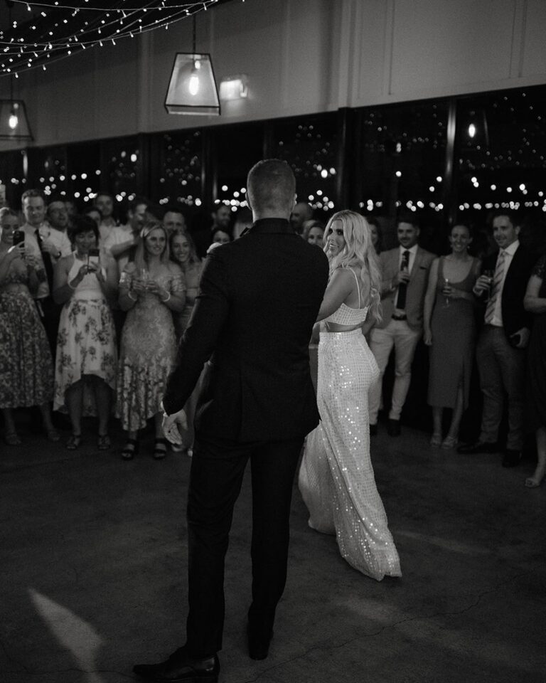 Newlyweds dancing together.