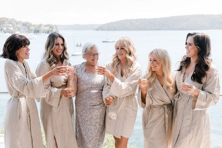 The bride and her bridesmaids toasting.