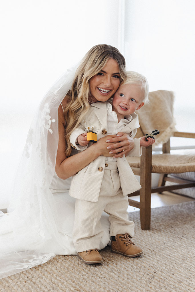 The bride hugging a little boy.