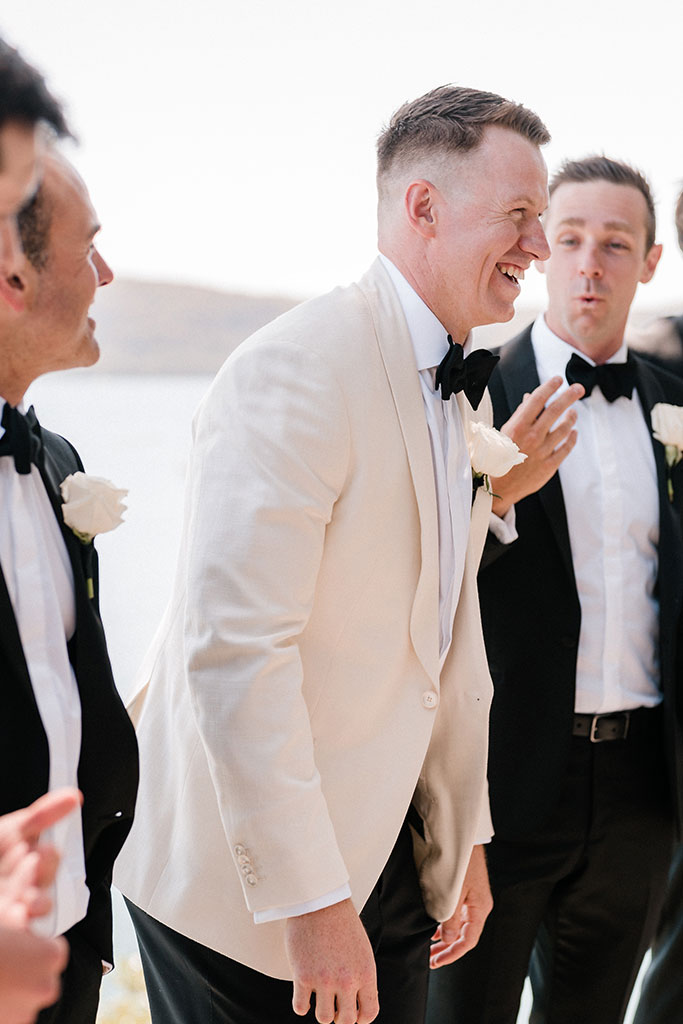 The groom smiling.