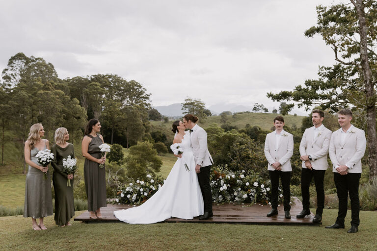 Wedding party celebrating in the mountains, surrounded by breathtaking scenery.
