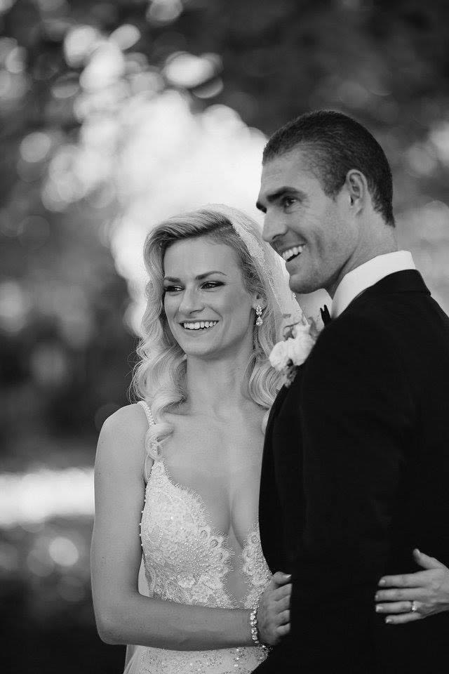 A happy bride and groom standing together, smiling on their special day.