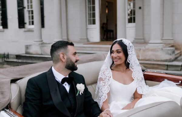 A bride and a groom in a car.