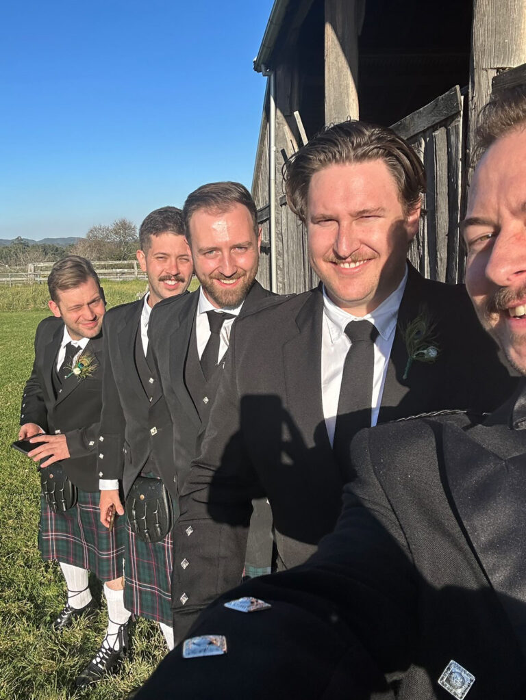 The groom taking the 'last photo of the ceremony' with his groomsmen!