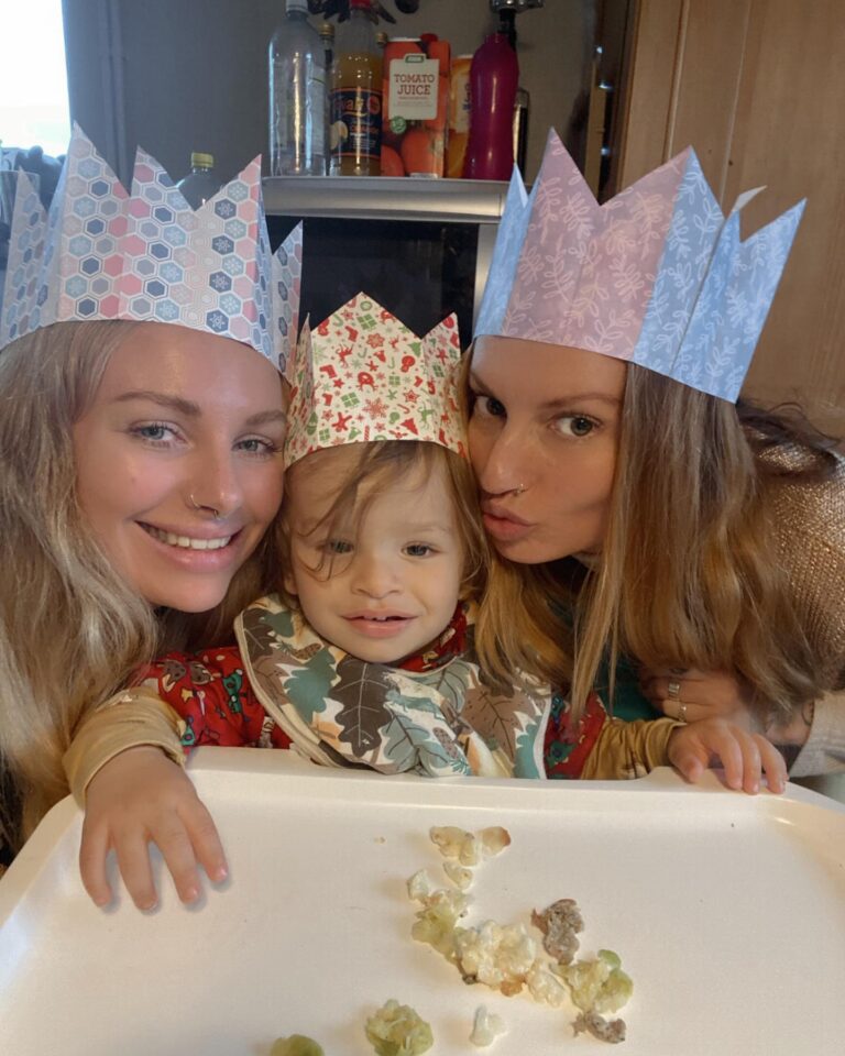 Two women and a baby boy in the middle.