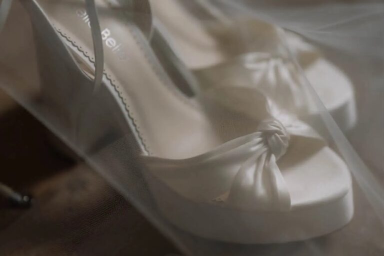 a pair of wedding shoes for a bride covered in a veil