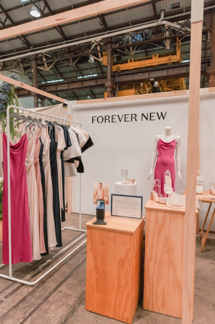 A clothing display with a sign that says Forever New.