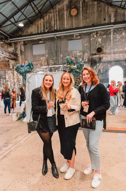 Three women smiling for a picture.
