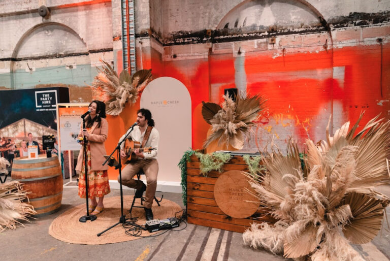 A man playing guitar and a woman singing.
