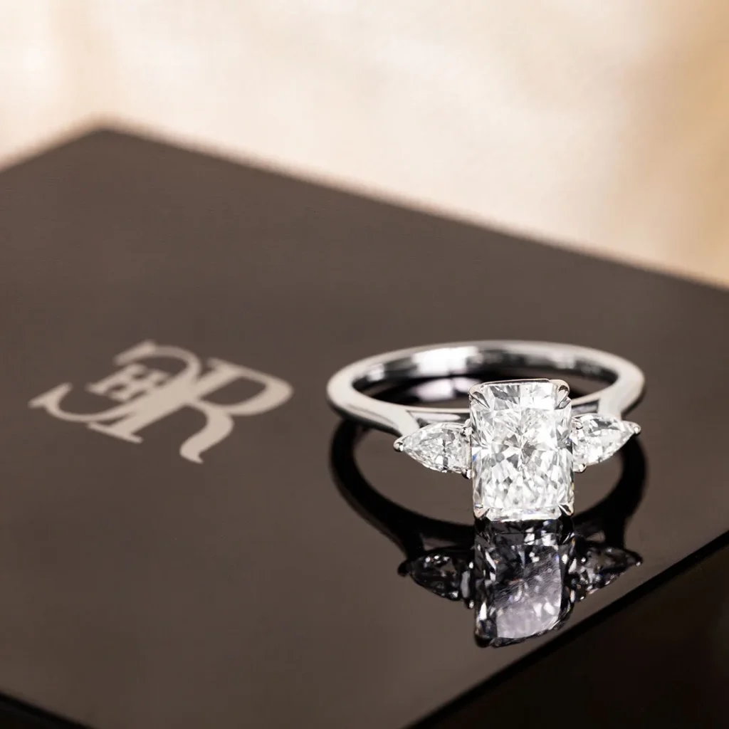 A beautifully crafted diamond ring placed on a box, representing the finest engagement ring by Charles Rose Jewellers