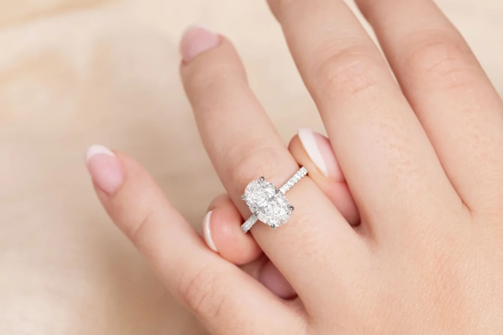 A woman's hand presents a stunning diamond engagement ring from Charles Rose Jewellers, emphasizing its sparkle and elegance