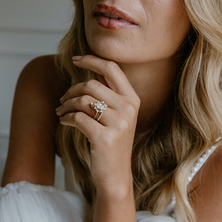Close-up of a bride wearing a diamond gold band, showcasing luxury engagement rings Melbourne jewellers offer.