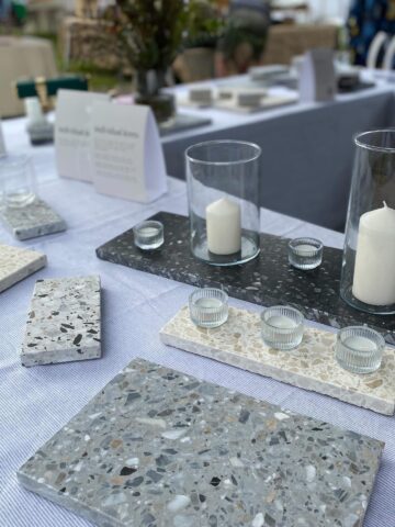 Table decorated with assorted stones and candles, creating a serene and enchanting wedding ambiance by Insieme Homewares, best wedding event hire Melbourne.