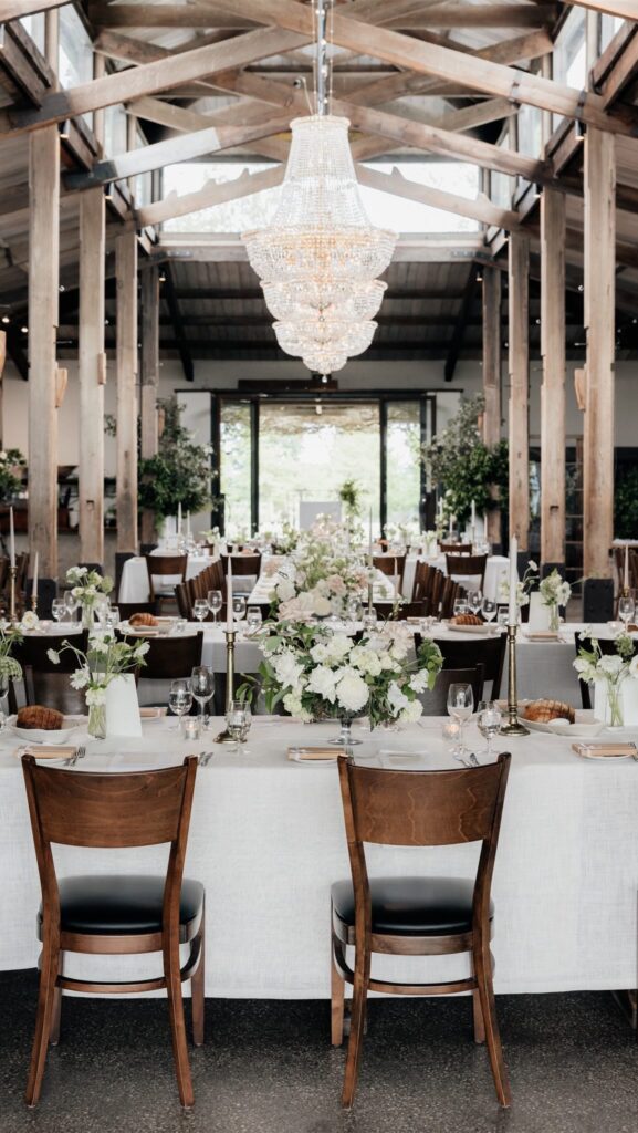 Rustic barn wedding reception decorated with white and green flowers, styled by Cloth and Confetti, best wedding event hire Melbourne.