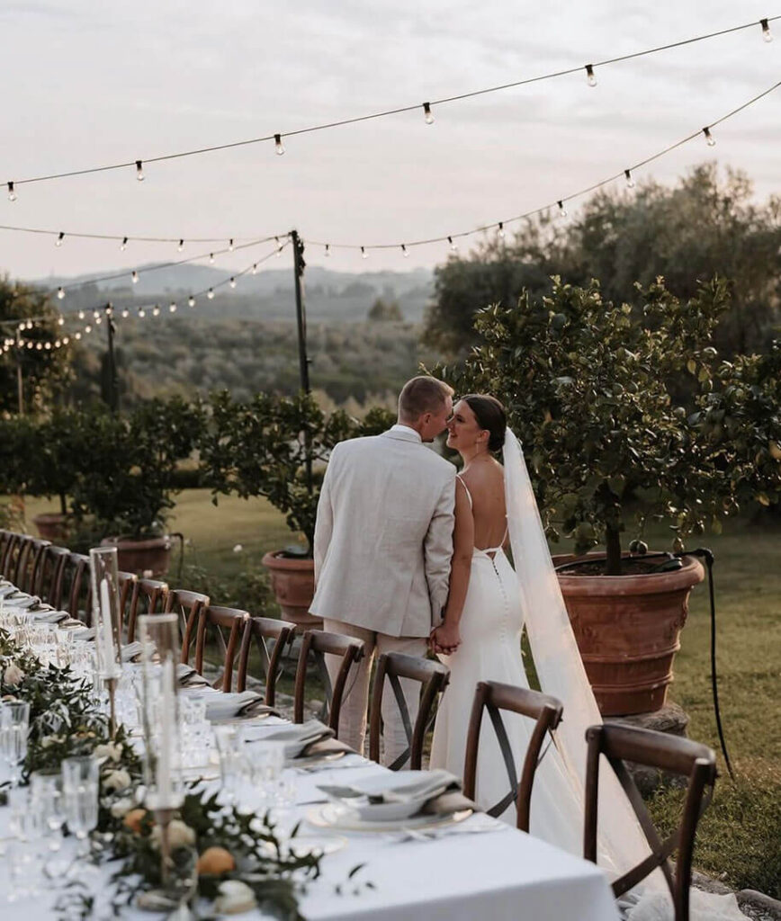 A couple standing in an outdoor wedding venue setup by You're Invited Event Hire, best wedding event hire Melbourne.