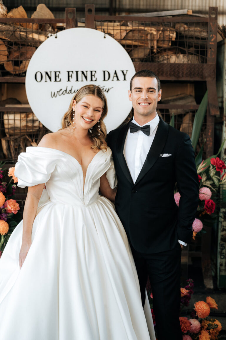the bride in a beautiful wedding dress with her groom and they are surrounded by flowers