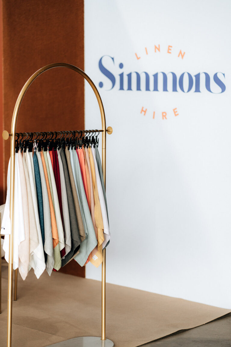 A rack with colorful shirts hanging on it.
