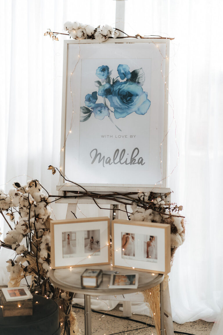 A sign at a wedding reception with elegant calligraphy, directing guests to the celebration.