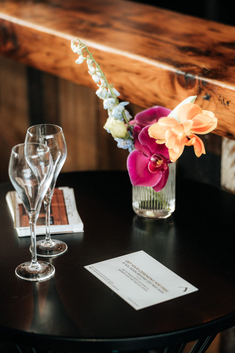 Table with two glasses and a card on it