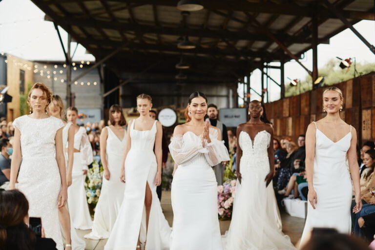 Models showcasing elegant gowns on a bridal runway at an Australian wedding expo