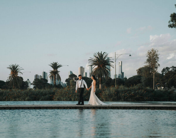 Venues Listing Category Lakeside Pavilion Romantic couple standing by the pool at Lakeside Pavilion, wedding venues in Melbourne with scenic waterfront views.