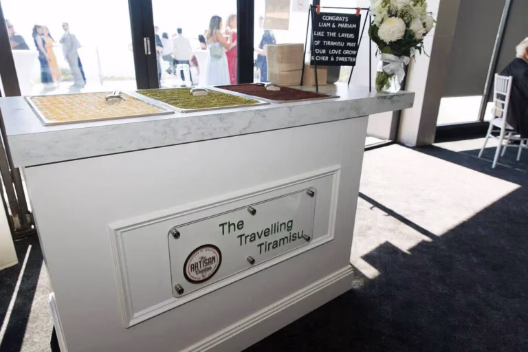 Wedding cake designer table with signage styled beside The Travelling Tiramisu Food Truck for weddings