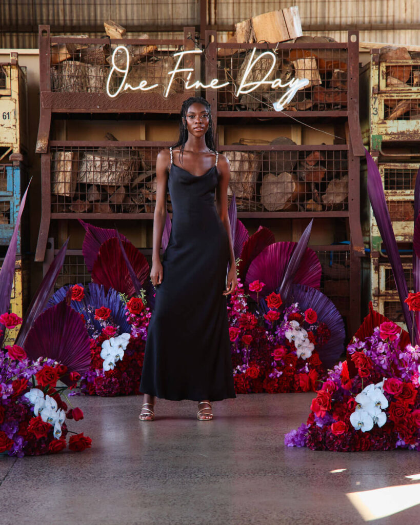 Bridal runway show in Melbourne showcasing a model wearing a unique black strappy satin wedding dress.