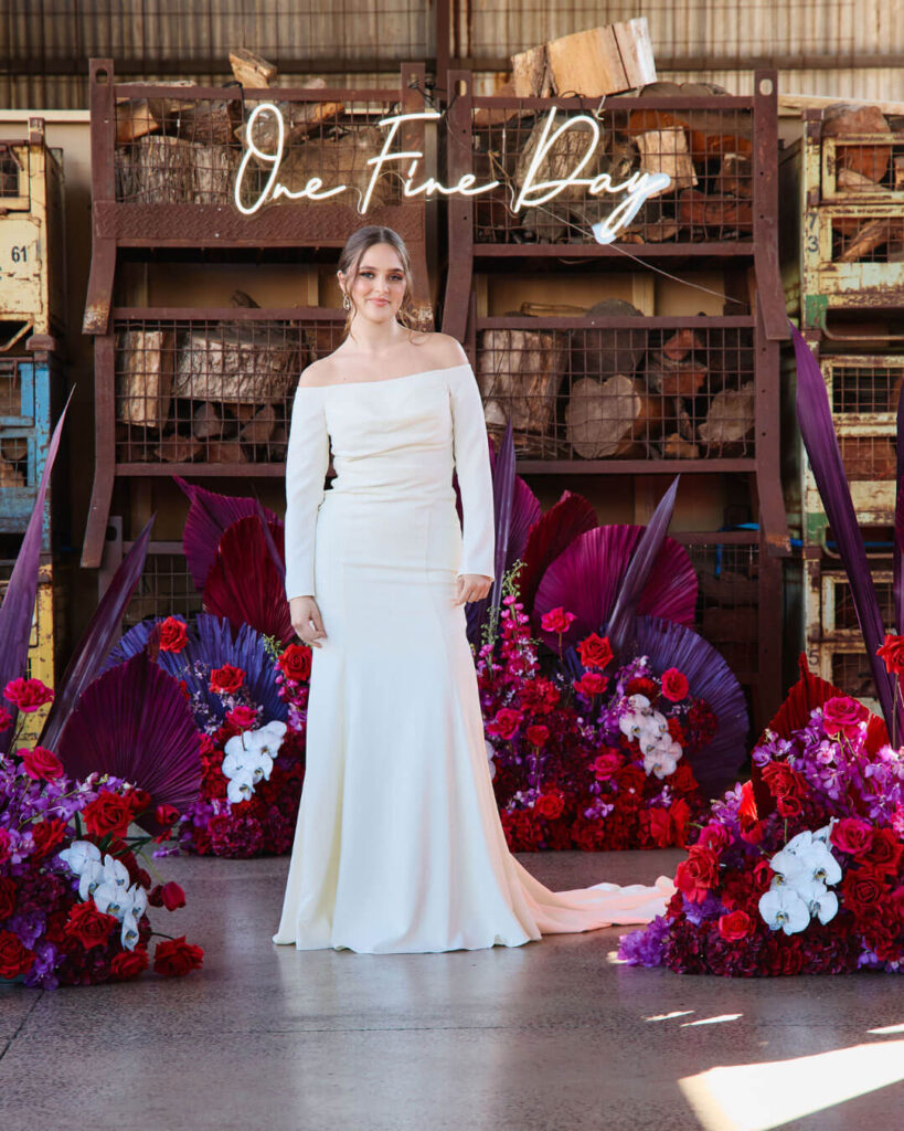 Stylish off-shoulder long sleeve wedding dress showcased on the catwalk during a bridal runway show in Melbourne.