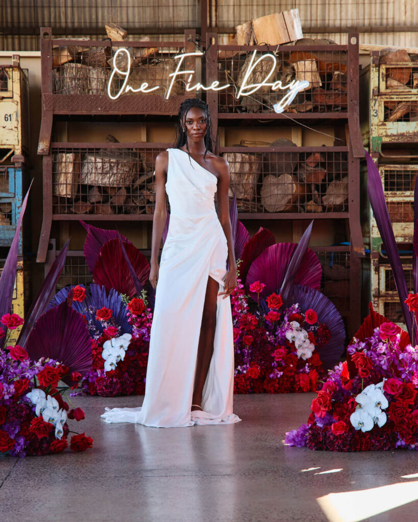 Bridal runway show in Melbourne featuring a modern one-sided shoulder wedding gown with high-thigh slit.