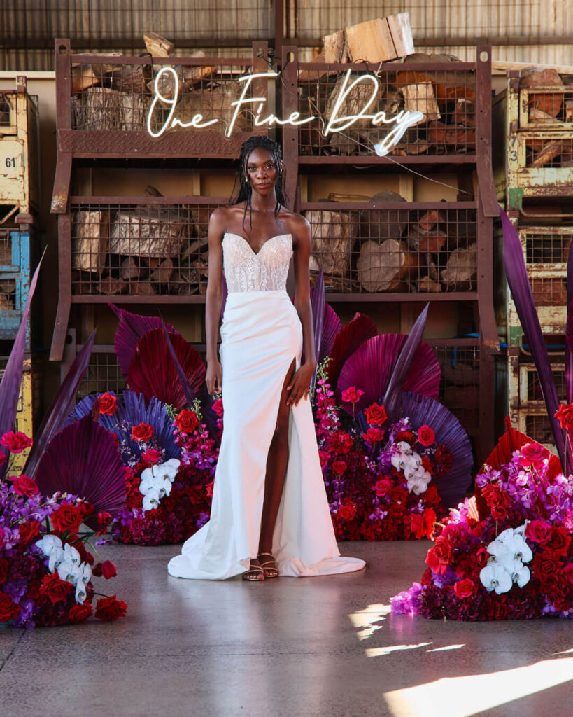 Bridal runway show in Melbourne featuring a modern strapless fitted bridal gown with high thigh slit.