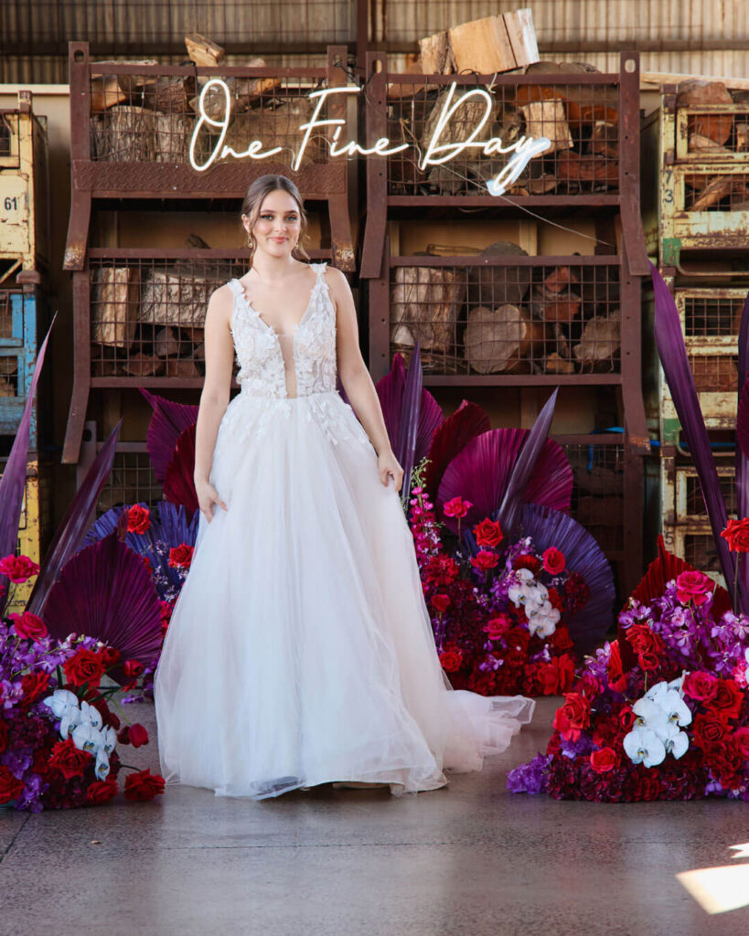 Bridal runway show in Melbourne featuring an elegant sleeveless ball gown wedding dress with deep V-neck and flowing tulle skirt.