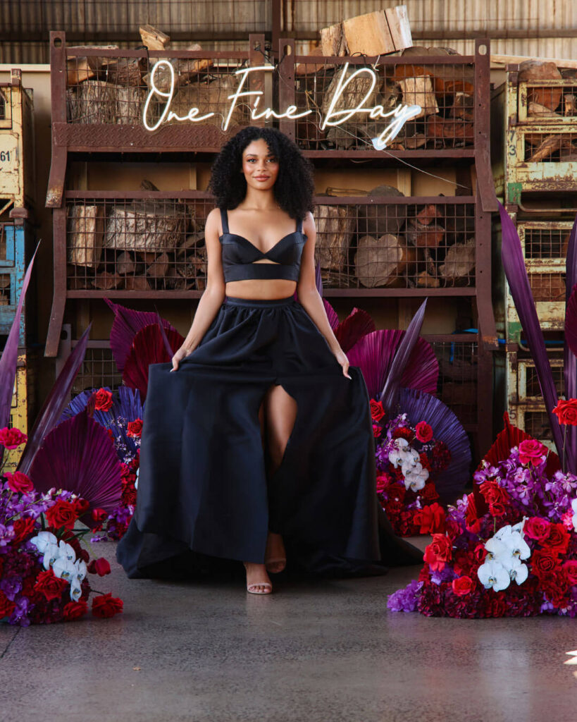 Bridal runway show in Melbourne featuring a modern black two-piece bridal gown with high thigh slit skirt.