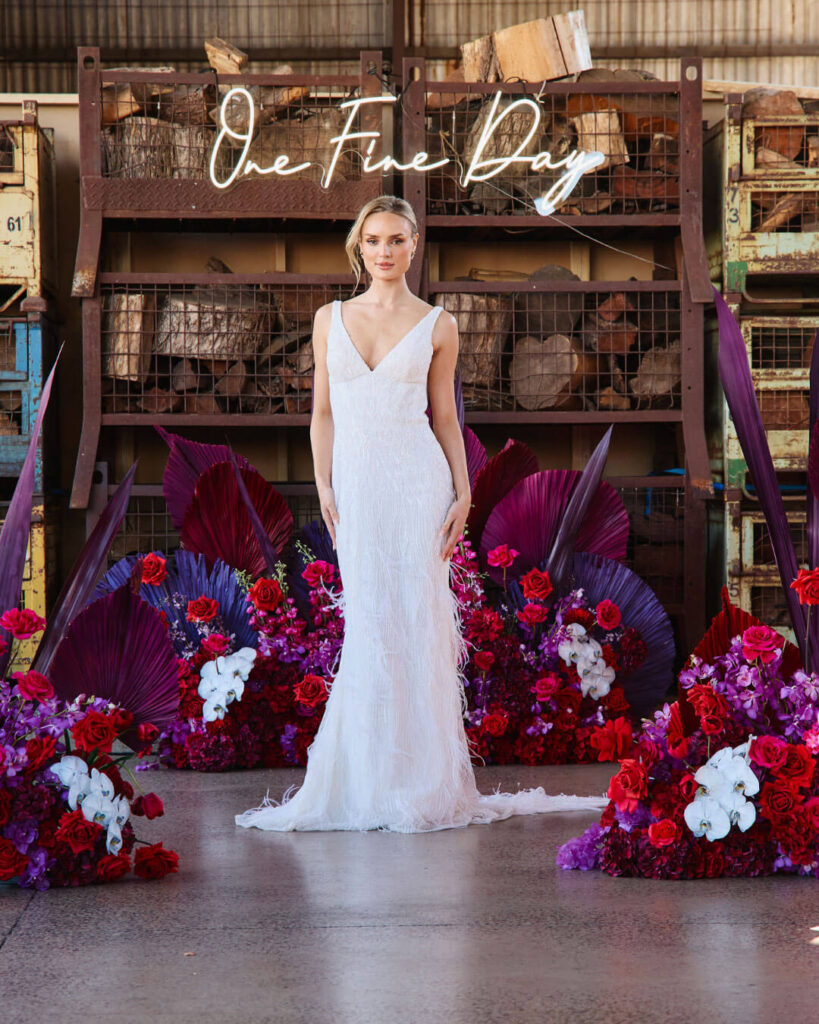 Deep V-neck fitted wedding dress showcased on the catwalk during a bridal runway show in Melbourne.