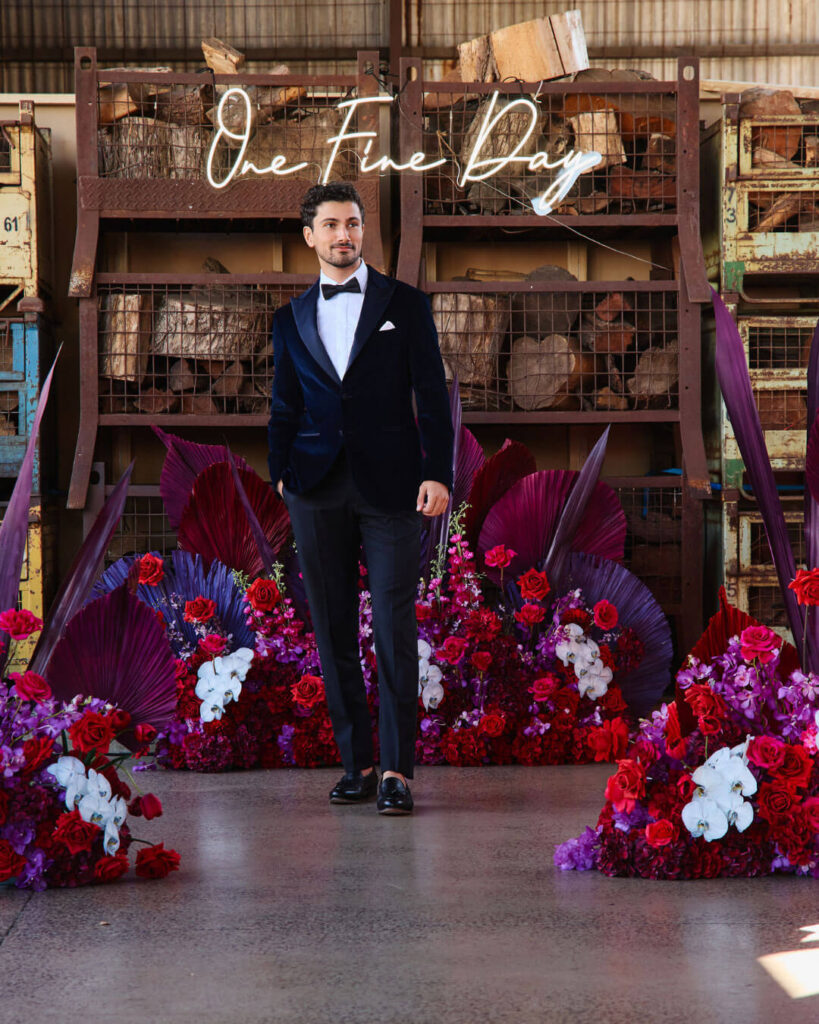Elegant dark velvet wedding suit paired with black pants, white shirt and bow tie during a bridal runway show in Melbourne.