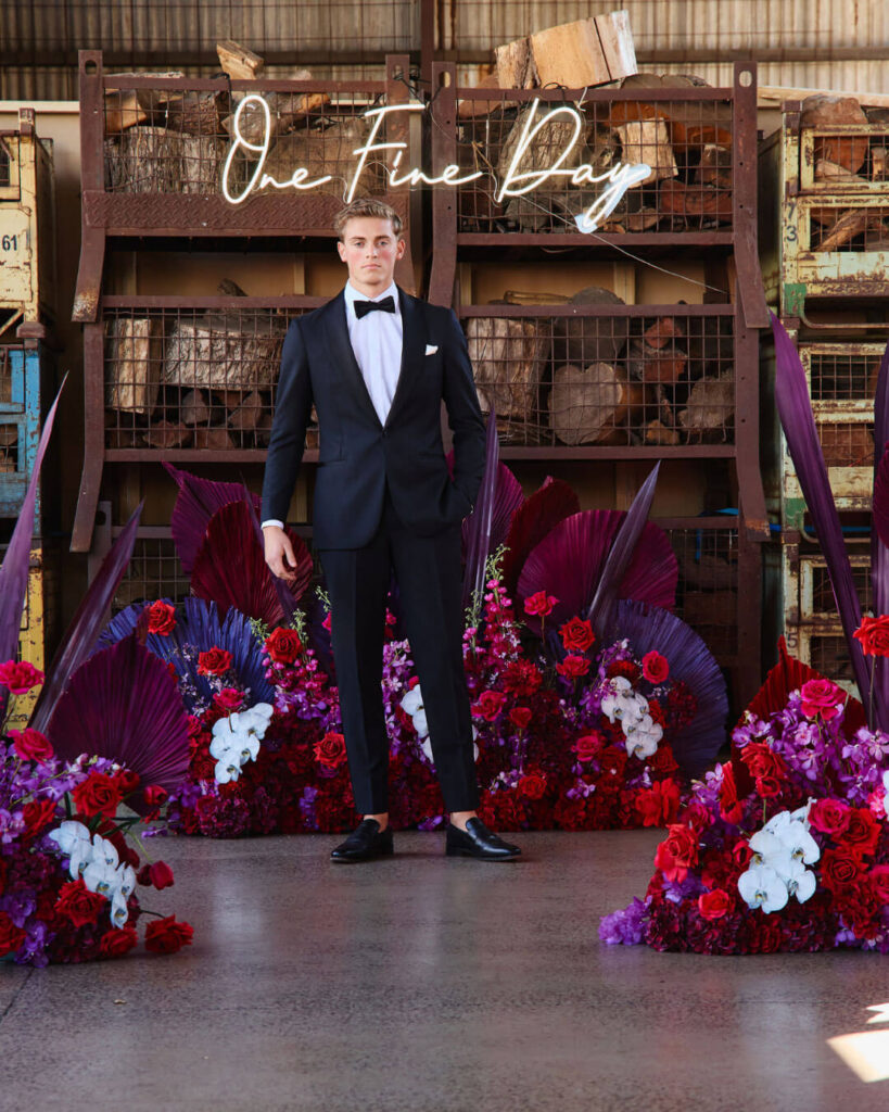 Bridal runway show in Melbourne featuring a groom model in a classic black wedding suit with bow tie and white shirt.
