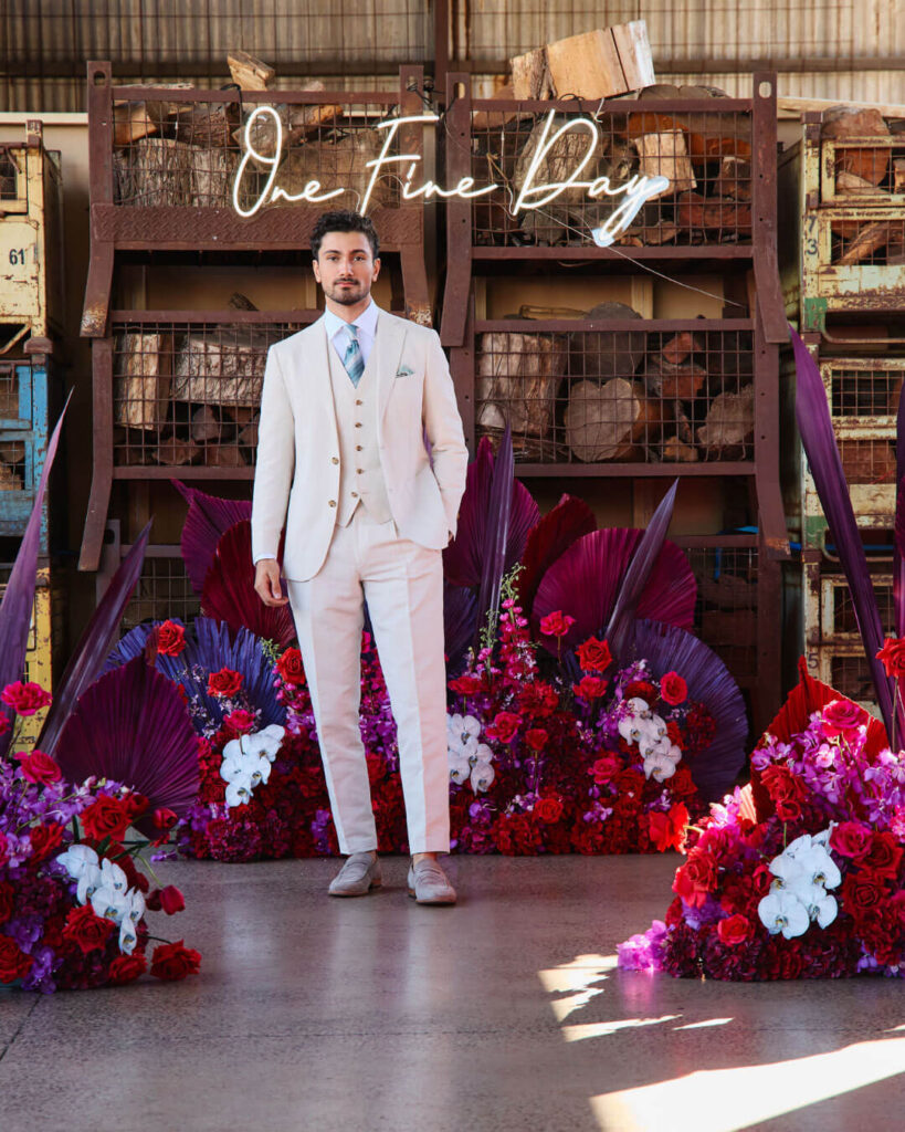 Man wearing a cream wedding suit with matching pants and vest, white shirt and necktie at a bridal runway show in Melbourne.